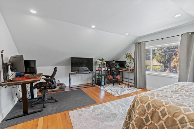 bedroom featuring lofted ceiling, recessed lighting, wood finished floors, and baseboards