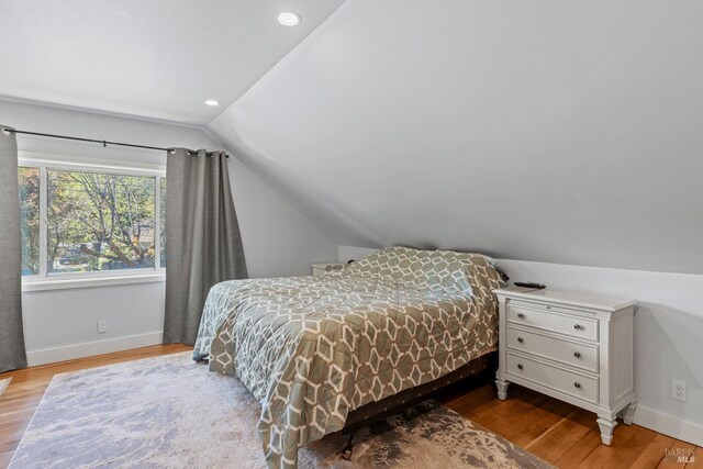 bedroom featuring lofted ceiling and carpet floors