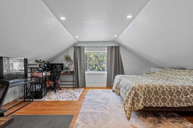 bedroom with lofted ceiling, recessed lighting, wood finished floors, and baseboards