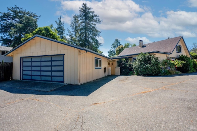 exterior space featuring a garage and a chimney