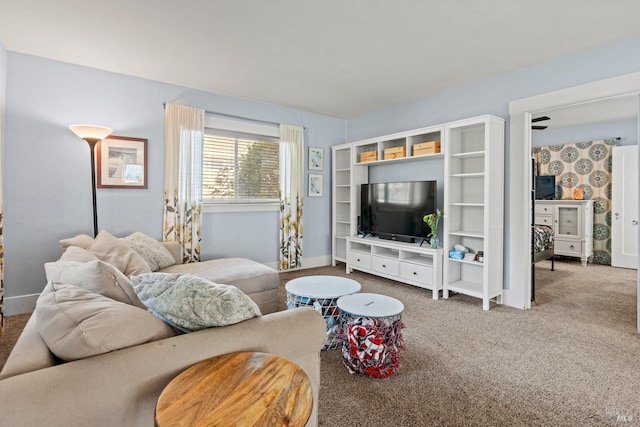 carpeted living room with baseboards