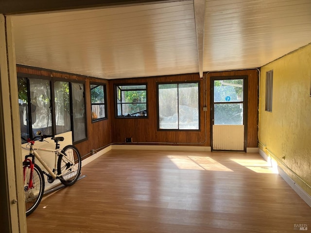 unfurnished sunroom with beamed ceiling