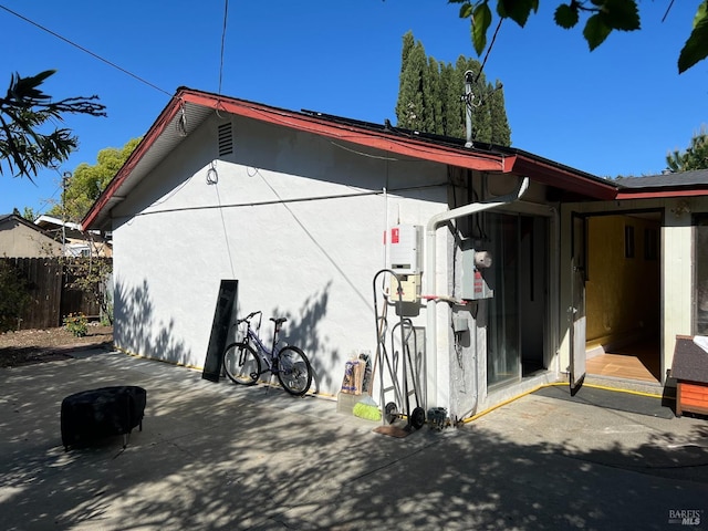 view of side of home with a patio area