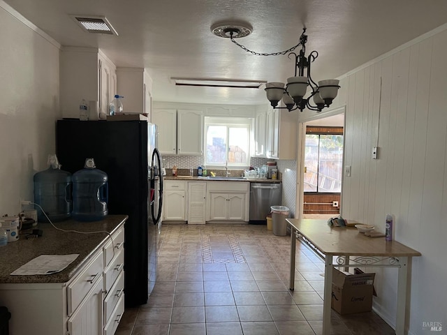 kitchen with backsplash, ornamental molding, dishwasher, and white cabinets