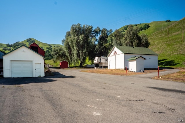 view of side of property with an outdoor structure and a garage