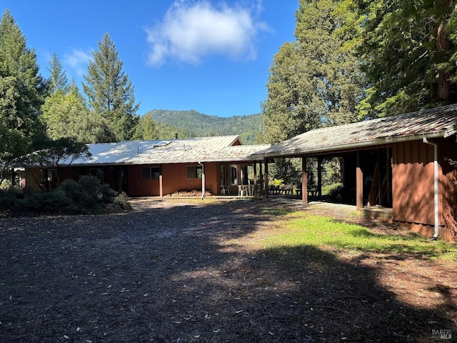 back of house with a mountain view