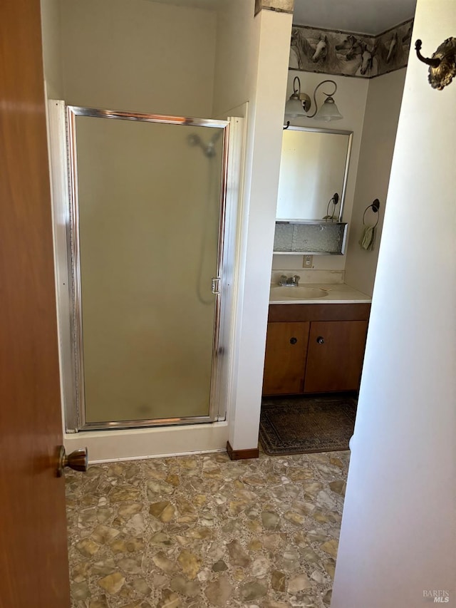 bathroom featuring an enclosed shower, tile floors, and vanity