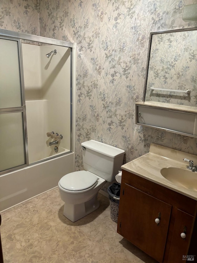 full bathroom featuring tile floors, toilet, bath / shower combo with glass door, and vanity