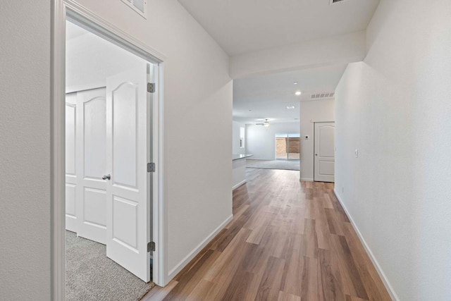 corridor with hardwood / wood-style floors