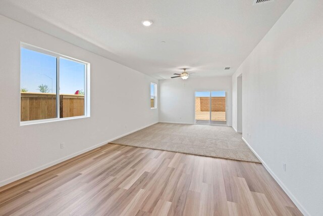 spare room with ceiling fan and light hardwood / wood-style flooring