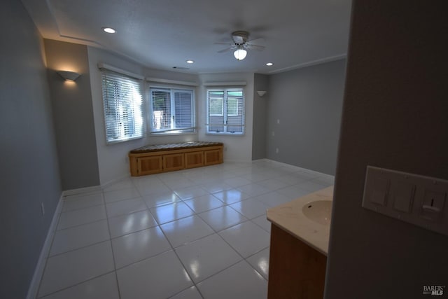 interior space with tile floors, ceiling fan, and vanity