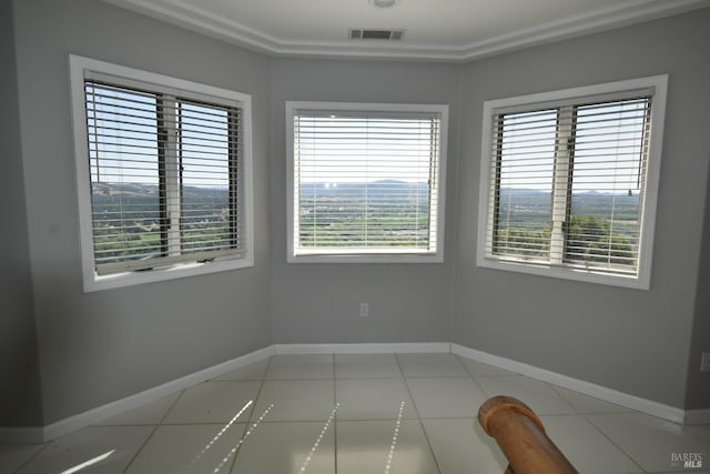 empty room featuring tile flooring and a healthy amount of sunlight