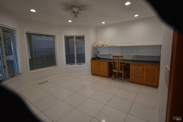 tiled home office featuring ceiling fan