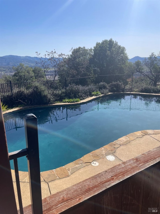 view of swimming pool featuring a mountain view