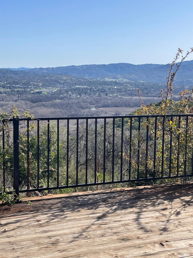 wooden deck featuring a mountain view