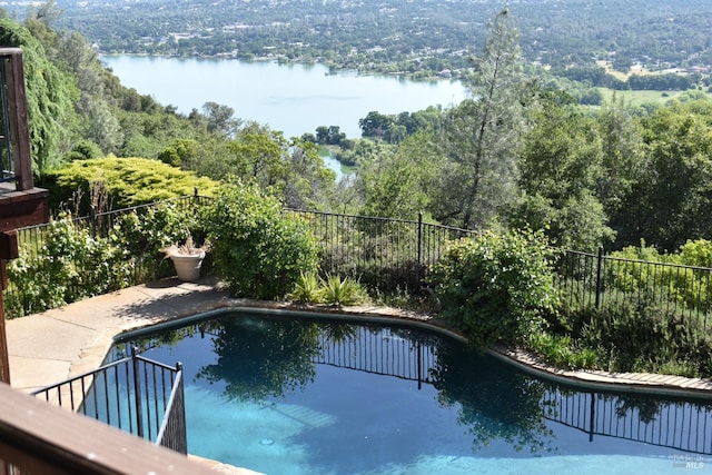 view of swimming pool featuring a water view