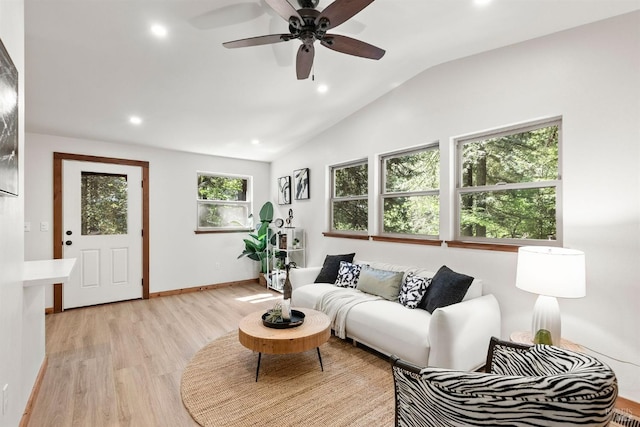 living room featuring vaulted ceiling, ceiling fan, and light hardwood / wood-style floors