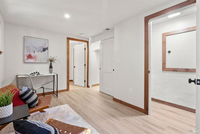 home office with light wood-type flooring, baseboards, and visible vents