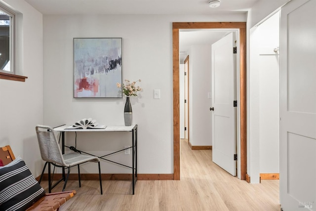 home office with light wood finished floors and baseboards