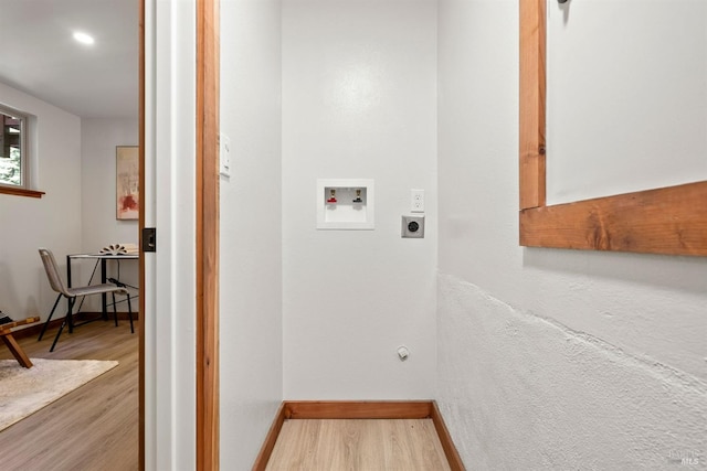 laundry room with hookup for an electric dryer, laundry area, washer hookup, wood finished floors, and baseboards