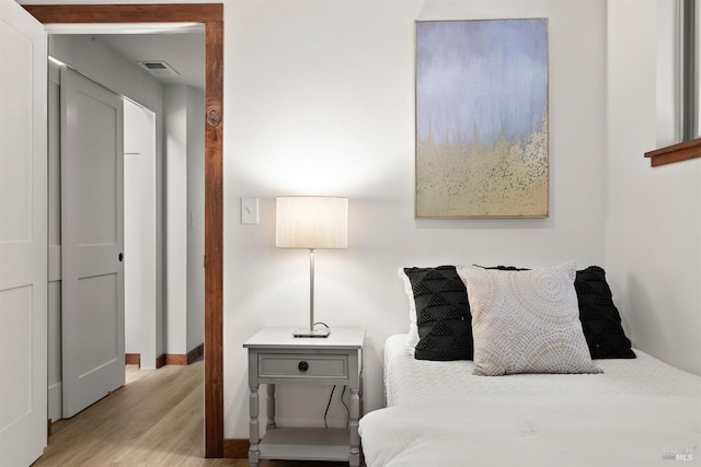 bedroom with light wood-type flooring and visible vents