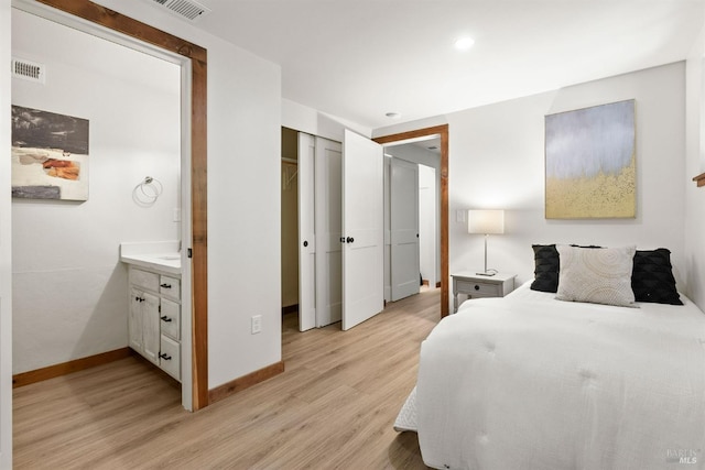 bedroom with light wood-type flooring, visible vents, and baseboards