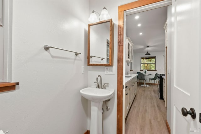 bathroom with a sink and wood finished floors