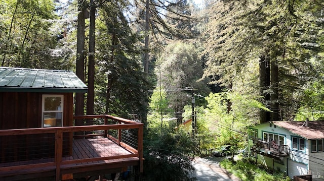 wooden deck with a view of trees