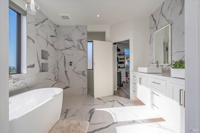 bathroom featuring large vanity, tile floors, and a bathing tub