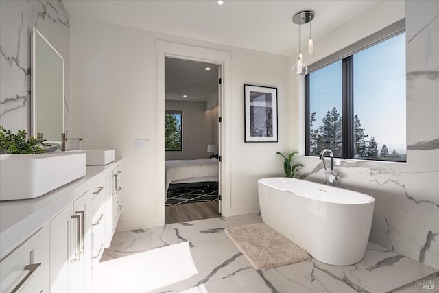 bathroom with tile walls, oversized vanity, tile floors, and a bathing tub