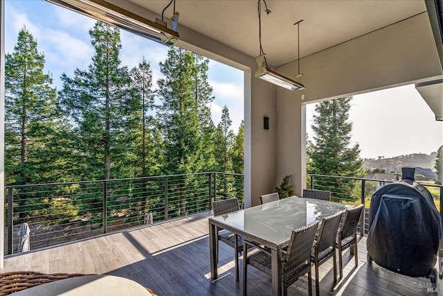 wooden terrace featuring a grill