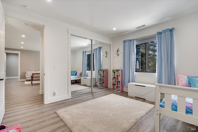 bedroom with wood-type flooring and a closet