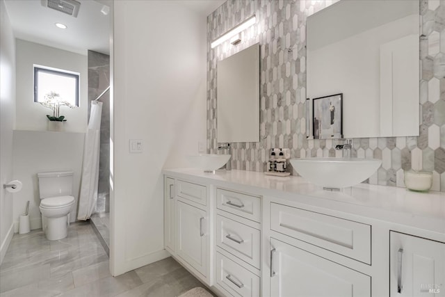 bathroom featuring double vanity, backsplash, toilet, and tile flooring