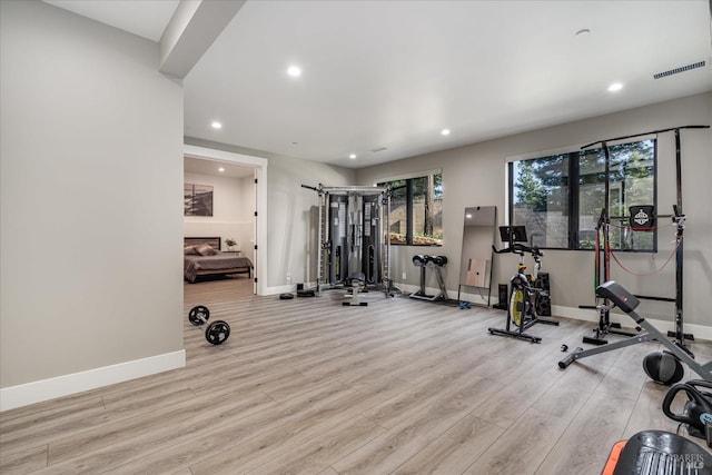 workout area featuring light wood-type flooring