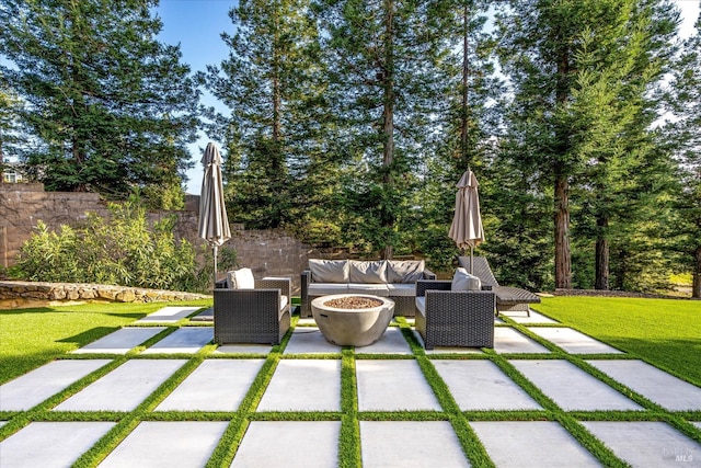 view of terrace featuring an outdoor living space with a fire pit