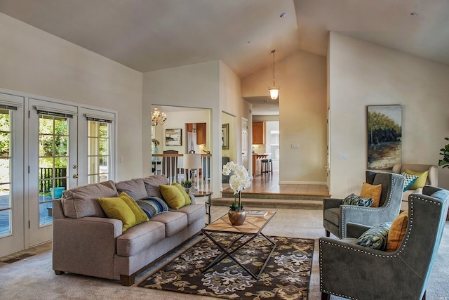 carpeted living room featuring high vaulted ceiling and french doors