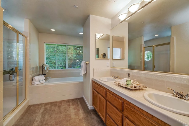 bathroom with shower with separate bathtub and vanity