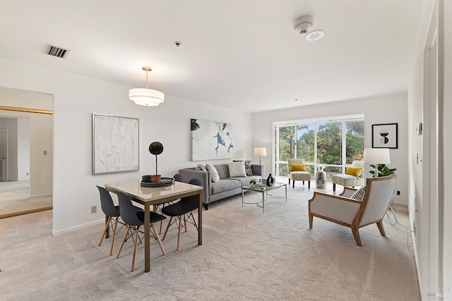 dining room featuring light carpet