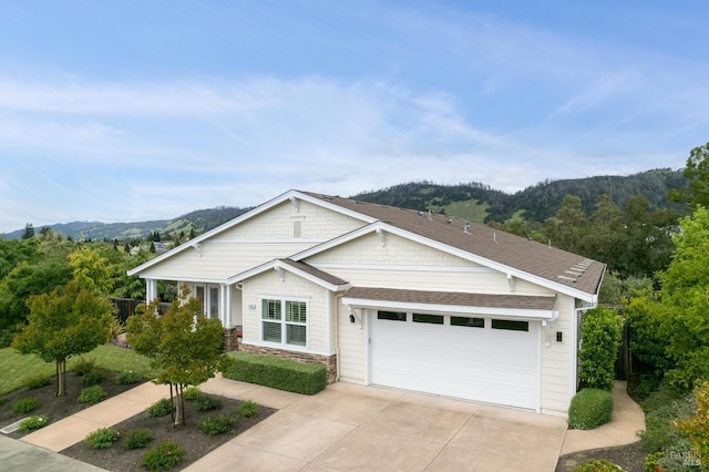 view of front facade featuring a mountain view and a garage