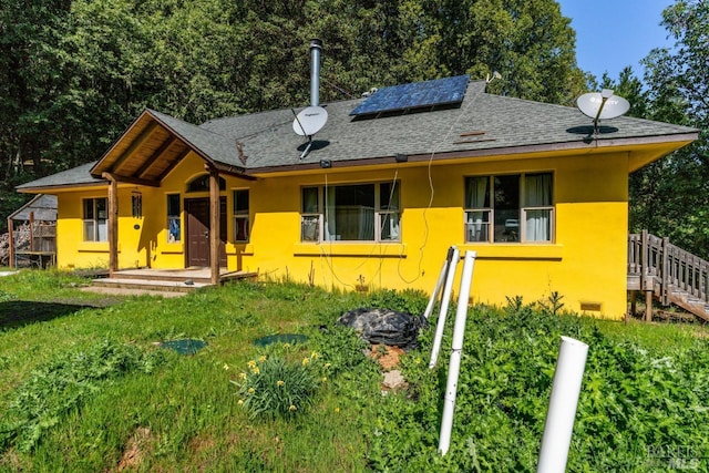27651 Skyview Rd, Willits, CA 95490 - view of front of home featuring solar panels, roof with shingles, stucco siding, and a front yard