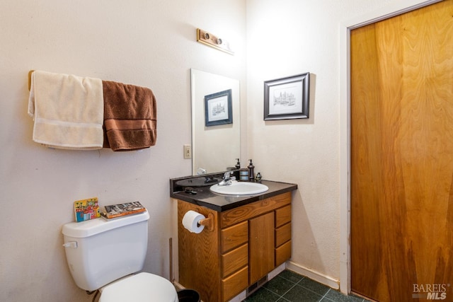 bathroom featuring tile floors, toilet, and oversized vanity