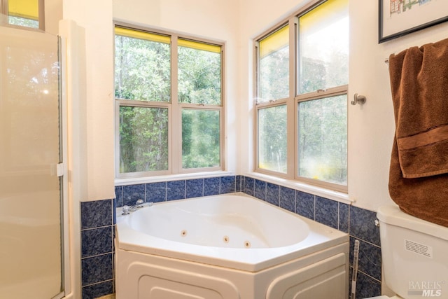 bathroom with tile walls, toilet, and separate shower and tub