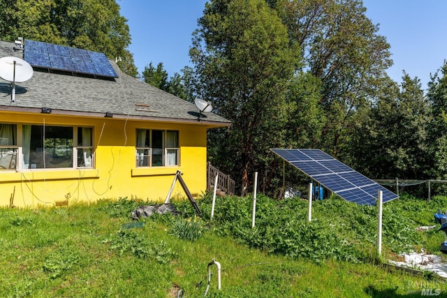 view of property exterior with solar panels