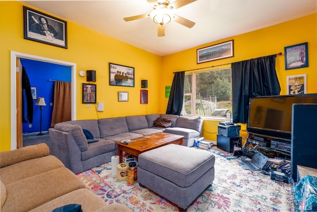 carpeted living room with ceiling fan