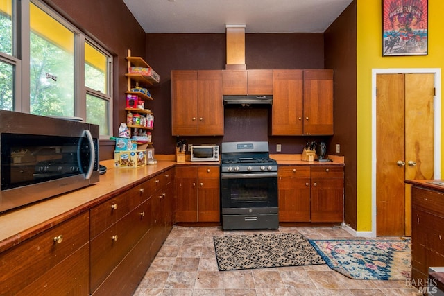 kitchen featuring appliances with stainless steel finishes and light tile floors