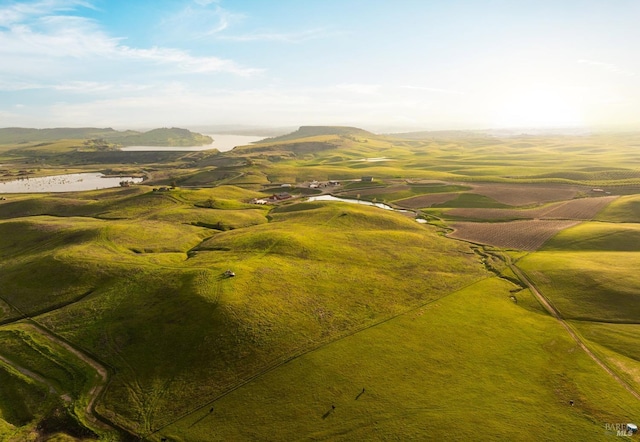 aerial view with a rural view and a water and mountain view