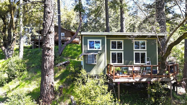 rear view of house with a wooden deck