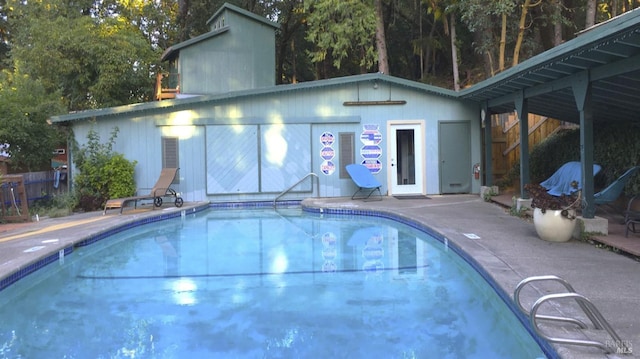 view of swimming pool featuring a patio area and an outdoor structure