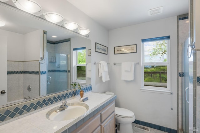 bathroom with walk in shower, toilet, tile floors, and large vanity