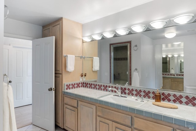 bathroom with tasteful backsplash, tile floors, and large vanity